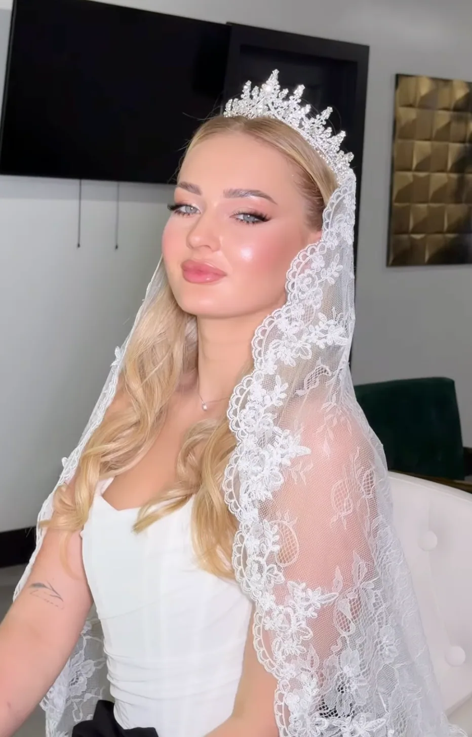 Bridal makeup with a lace veil and crystal tiara